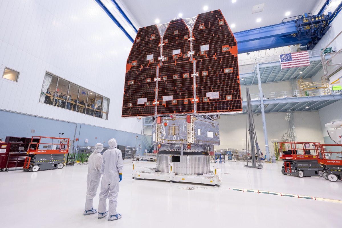 The assembled Roman observatory and two technicians in NASA Goddard's cleanroom, November 2025